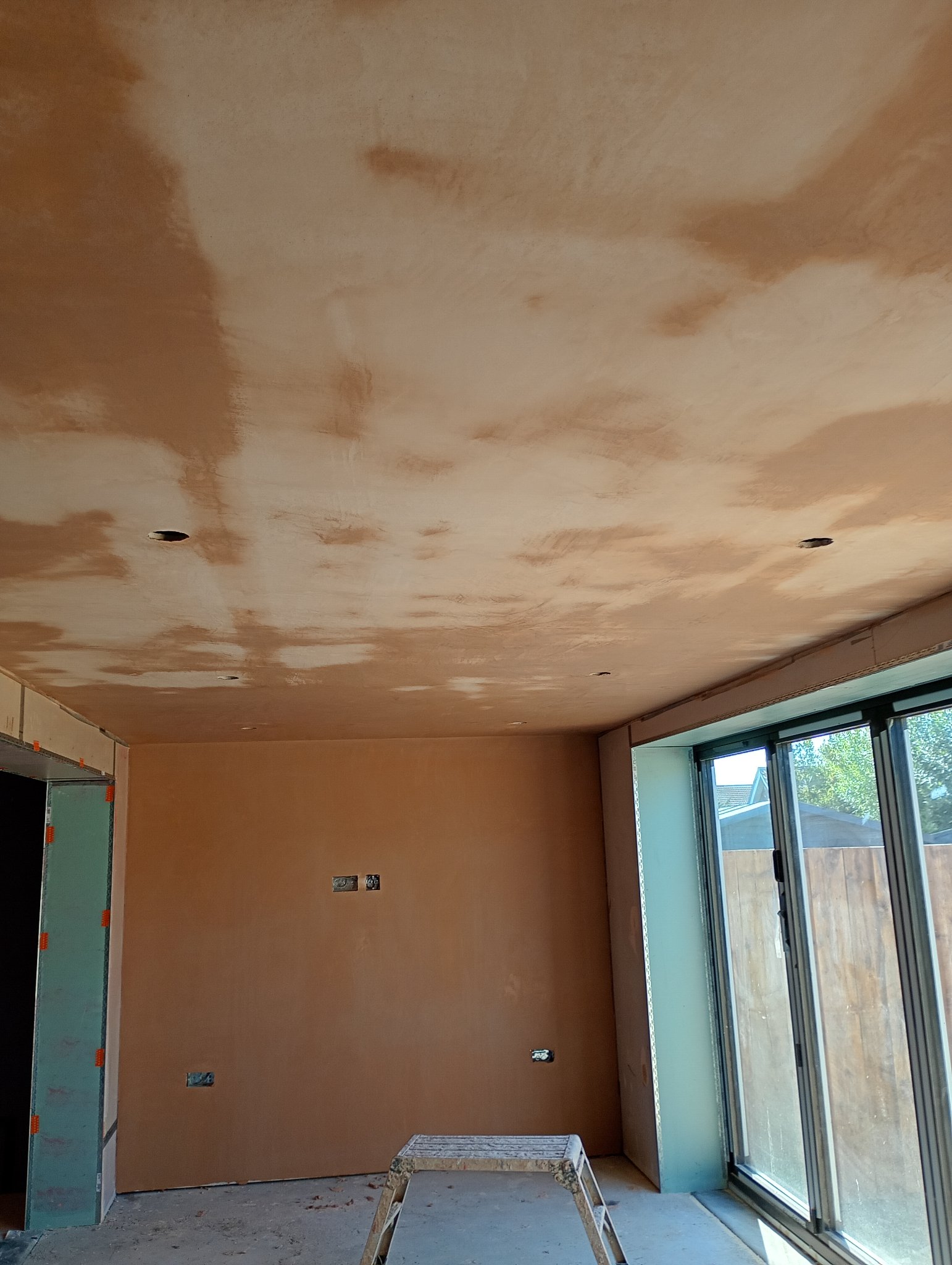 Skimmed ceiling and wall beside the bifold doors after plastering in Whitstable